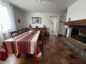 a dining room with a table and a fireplace at Maison jeanborde in Serreslous-et-Arribans +18 photos