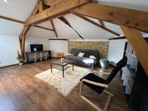a living room with a bed and a table at Maison jeanborde in Serreslous-et-Arribans