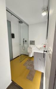a bathroom with a glass shower and a toilet at Lambrusco - Harbor's Light in Villajoyosa +13 photos