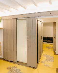 a row of doors in a room with a couch at Lambrusco - Harbor's Light in Villajoyosa