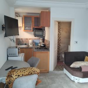 a small kitchen with a table and a couch at Residence djerba 1 in Houmt Souk