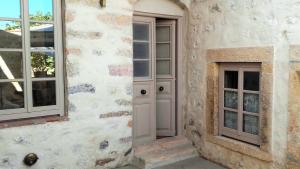 a door and windows on the side of a building at En Patmo Holiday Home in Patmos
