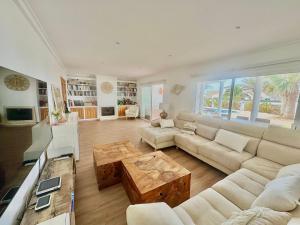 a living room with a couch and a coffee table at Villa Coral in Cala en Blanes