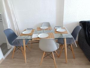 a dining room table with four chairs and a marble table and chairsktop at Fréjus balcon des arènes in Fréjus +17 photos