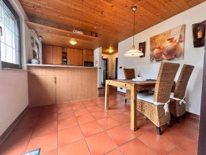a kitchen and dining room with a table and chairs at Ferienwohnung Buronia 2 in Kaufbeuren