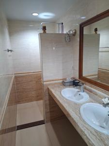 a bathroom with a sink and a mirror and a shower at Cozy Country House with Pool in Ban Nong Nam Khem +5 photos