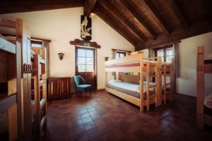 a room with two bunk beds in a house at Grünsee Mountain Lodge in Zermatt