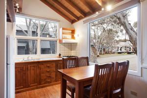 a kitchen with a table and chairs and a window at Gundy Lodge in Dinner Plain