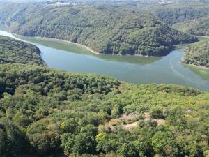 an aerial view of a river and forests at Le Pré Soutro in Arches