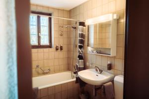 a bathroom with a sink and a tub and a toilet at Grünsee Mountain Lodge in Zermatt +33 photos