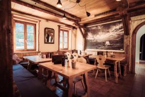a restaurant with wooden tables and chairs in a room at Grünsee Mountain Lodge in Zermatt