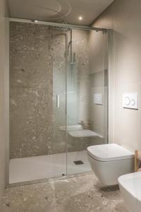 a bathroom with a shower and a toilet and a sink at Dimora Beggiami by Vayadù in Savigliano +21 photos