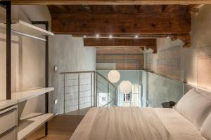 a bedroom with a bed and a glass wall at Dimora Beggiami by Vayadù in Savigliano