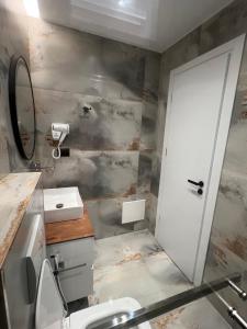 a bathroom with a toilet and a sink and a mirror at House Pollo in Ksamil +113 photos