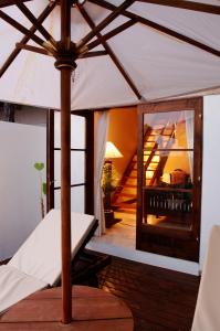 a white umbrella sitting on top of a porch at Resort Hotel Corte Largo Izu Kogen in Ito