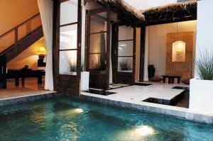 a villa with a swimming pool in front of a house at Resort Hotel Corte Largo Izu Kogen in Ito
