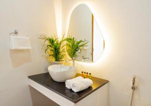 a bathroom with a sink and a mirror at Ananas Beach Resort in Agonda
