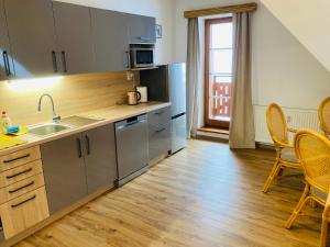 a kitchen with a sink and a table and chairs at Dolní Náměstí in Rokytnice nad Jizerou +27 photos