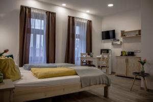 a bedroom with a bed and a table and a desk at Hont Vendégház in Hont +24 photos