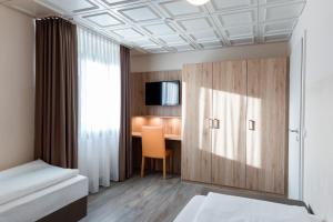 a bedroom with a desk and a bed and a cabinet at Römerhof in Stuttgart +34 photos