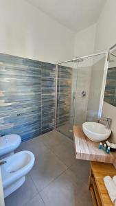 a bathroom with two sinks and a shower at Thai Boutique rooms in Peschici +73 photos