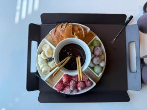 a plate of food with a cup of coffee and fruit at COVE Stay-611 in Chagyak-to