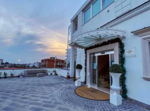 a white building with a patio with plants on it at Grand Hotel Royal in Pompei