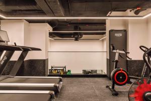 a gym with a treadmill and a bike at Locke de Santa Joana in Lisbon