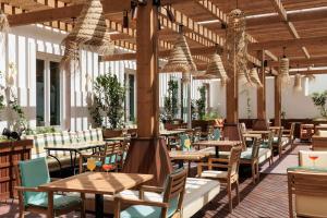 a restaurant with wooden tables and chairs at Locke de Santa Joana in Lisbon
