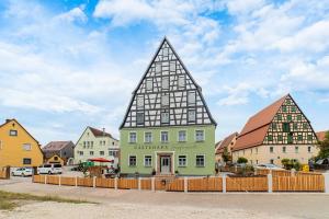 a building with two triangular roofs in a town at Gästehaus Hopfenperle in Spalt