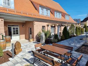 a picnic table and benches in front of a house at Privat SPA Premium Suite 117 qm in Wehlenberg