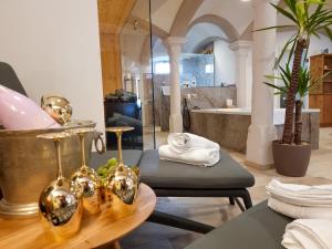 a bathroom with a table and a tub and a sink at Privat SPA Premium Suite 117 qm in Wehlenberg +30 photos