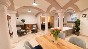 a living room with a table and a bath tub at Privat SPA Premium Suite 117 qm in Wehlenberg