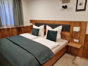 a bedroom with a bed with green and white pillows at Privat SPA Premium Suite 117 qm in Wehlenberg