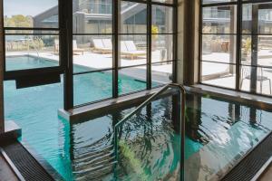 a swimming pool in a building with windows at Season Hotel in Ekerö