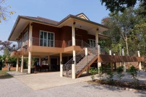 a house with a staircase in front of it at baan wongsupar in Suan Phung