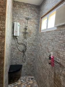 a bathroom with a shower in a brick wall at baan wongsupar in Suan Phung +13 photos