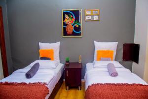 a room with two beds with pillows and a table at Umzimkulu Hotel in Umzimkulu