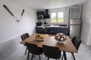 a kitchen with a wooden table with bowls of fruit on it at Domaine des Moizons, Le Laurier in Villebernier