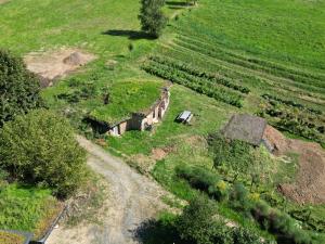 an aerial view of a farm with a car in a field at Le Pré Soutro in Arches