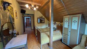 a bedroom with two beds in a room with wooden ceilings at Agroturystyka SPA in Zelków