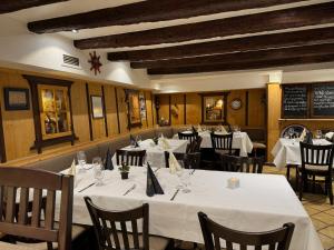 a restaurant with tables and chairs with white table cloth at Hotel Zum Schwarzen Walfisch in Bad Säckingen