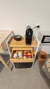 a small table with a black appliance on top of it at Thai Boutique rooms in Peschici