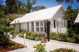 a white house with a statue in front of it at The Moso in Moso Island