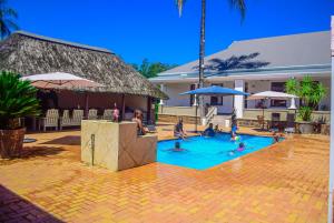 a group of people in a swimming pool at Umzimkulu Hotel in Umzimkulu