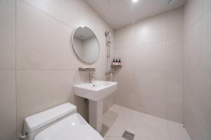a white bathroom with a sink and a mirror at Anook Hotel Daejeon Daeheung in Daejeon +57 photos