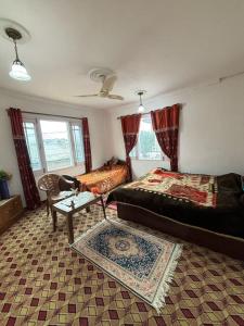 a living room with a bed and a couch at Karnai Residency in Srinagar