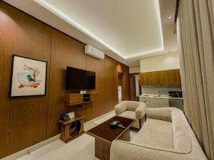 a living room with a couch and a tv at Tura Residence Al Khaleej- ترى للشقق المخدومة الخليج in Riyadh