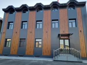 a blue building with wooden columns at ReveL HoteL in Tashkent