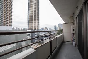 a balcony of a building with a view of a city at NIYS apartments 04 type in Tokyo